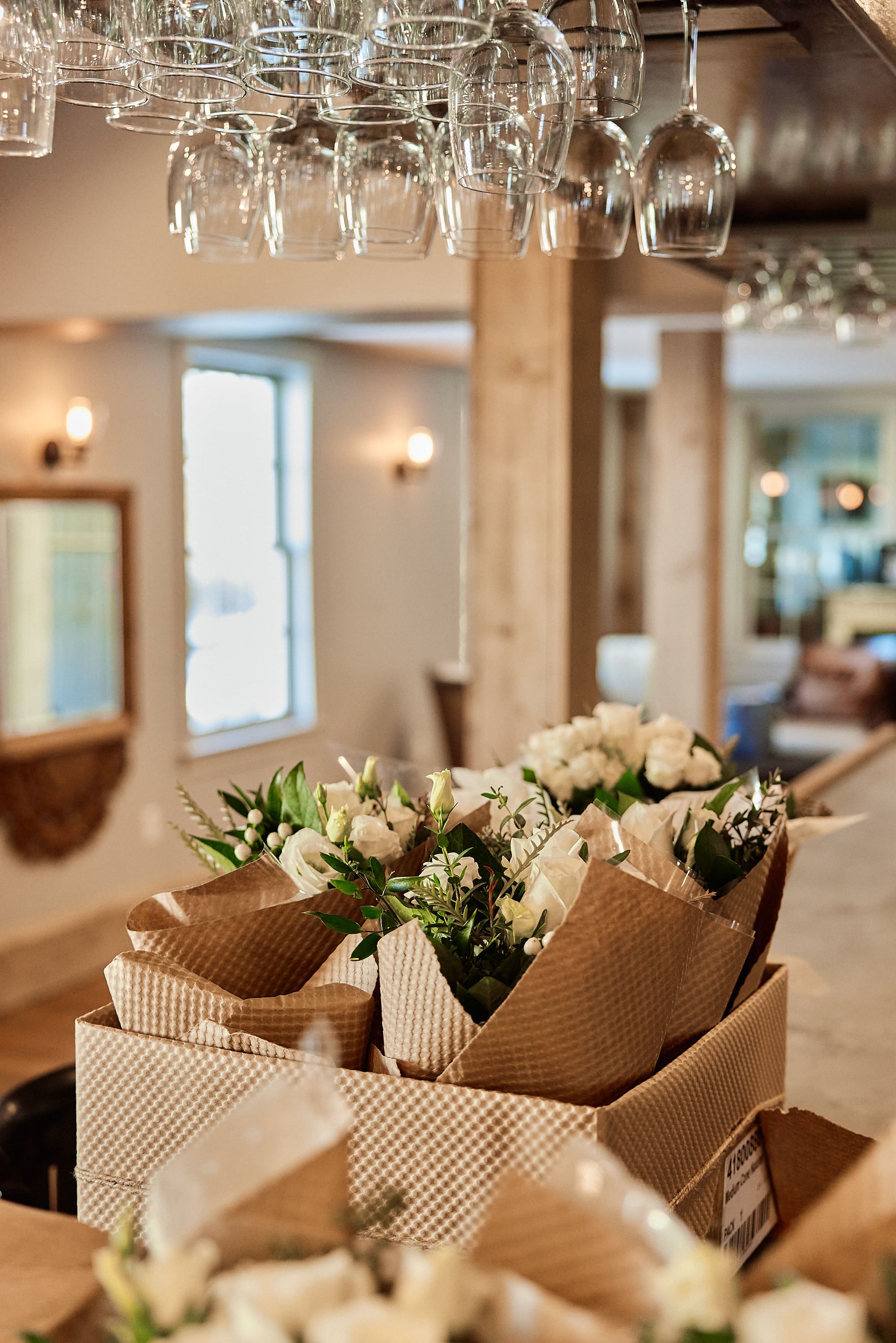 Detailed shot of floral arrangements and wine glasses at a Boston reception